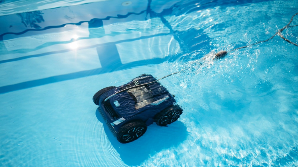 Robot nettoyeur de piscine en fonctionnement sous l’eau, aspirant le fond du bassin pour un entretien automatique.